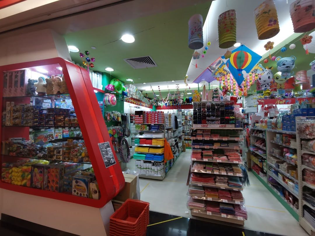 Interior view of a vibrant shop filled with toys, stationery, and party supplies, featuring colorful decorations.