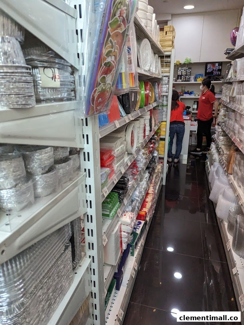 An aisle in SKP Clementi Mall, showcasing shelves stocked with baking and party supplies, with staff present.