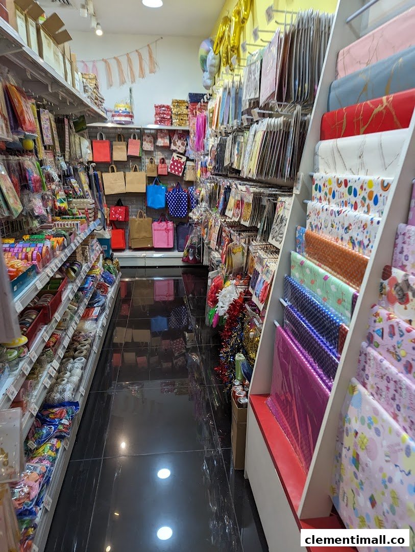 An aisle view inside a party supply and gift shop, showcasing wrapping paper, gift bags, and decorations.