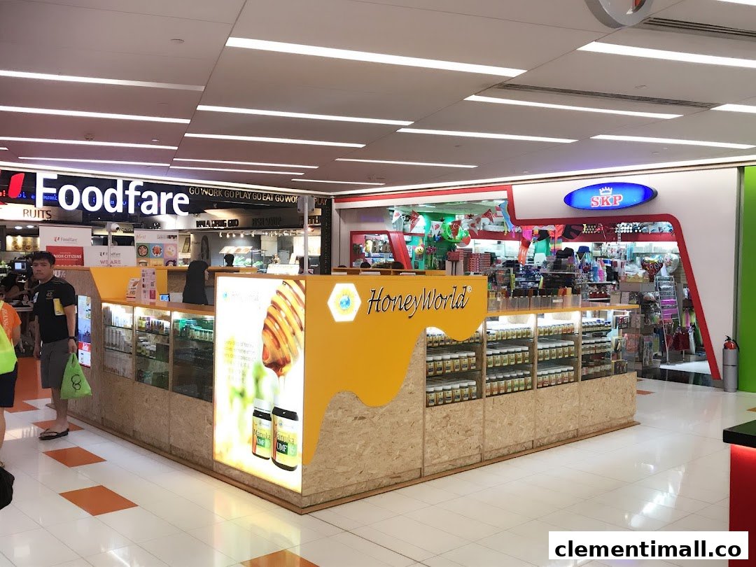 A mall interior featuring a HoneyWorld kiosk, SKP shop entrance, and Foodfare food court.