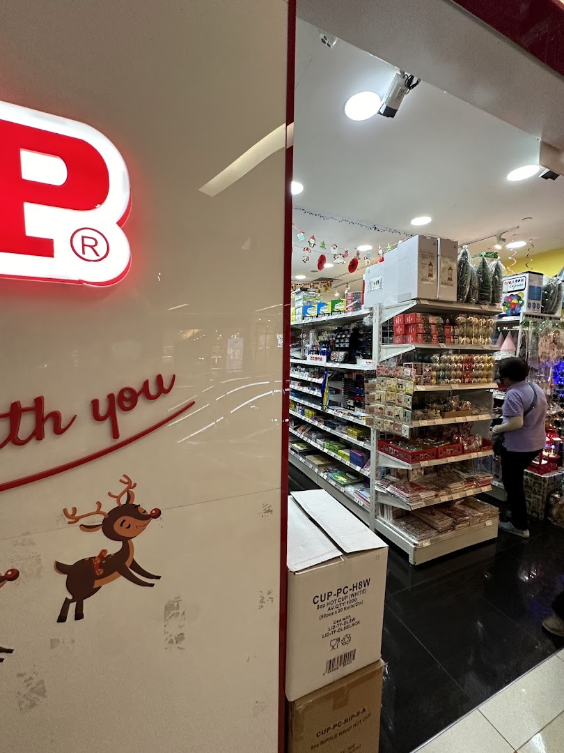 Interior view of SKP shop with shelves stocked with various products and a customer browsing, featuring festive decorations.