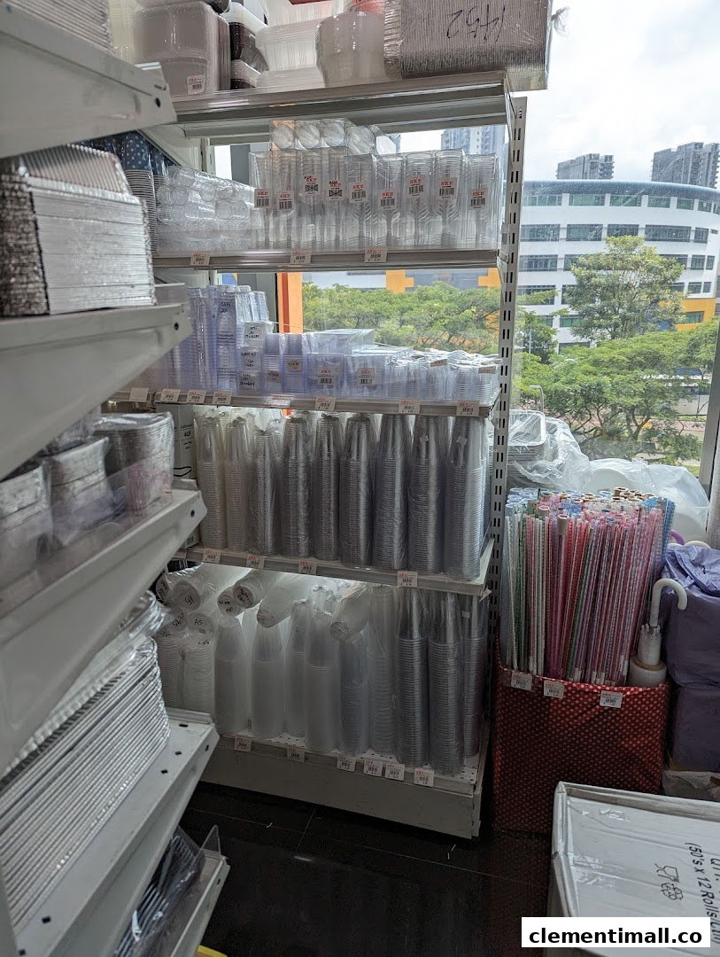 Shelves stocked with various disposable food containers, cups, and party supplies inside a retail store.