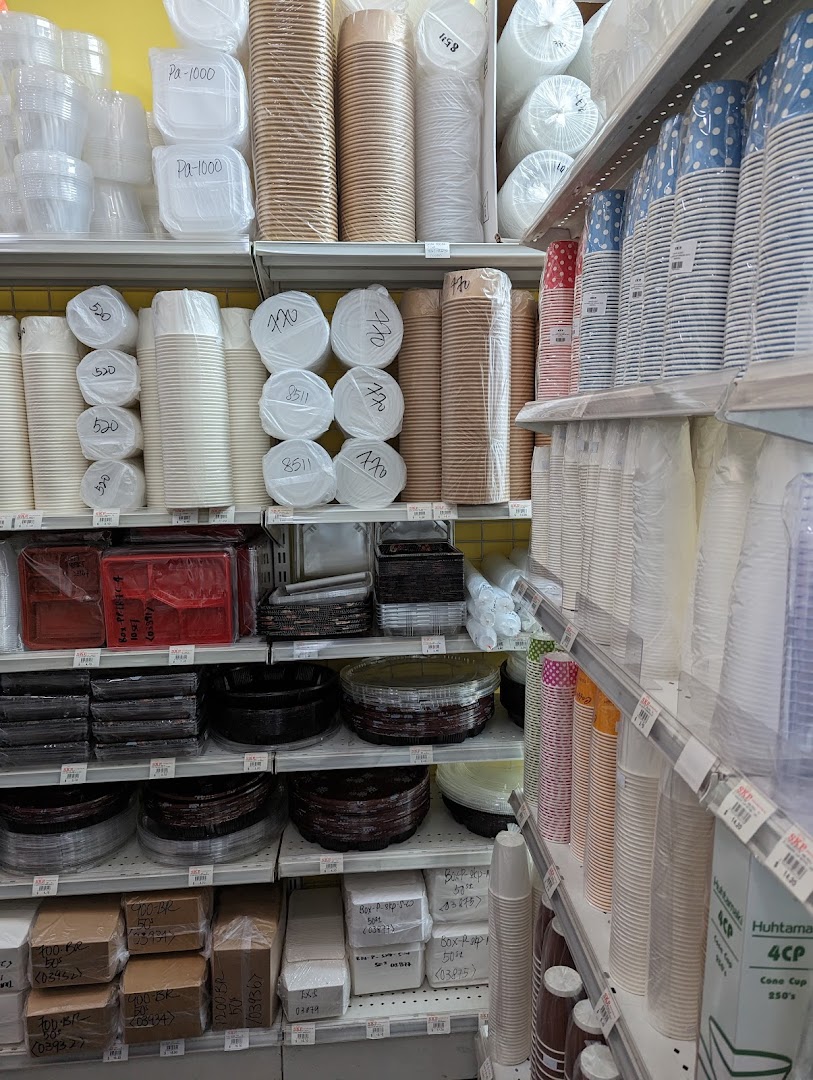 Shelves stocked with a wide variety of disposable food packaging, cups, and containers.