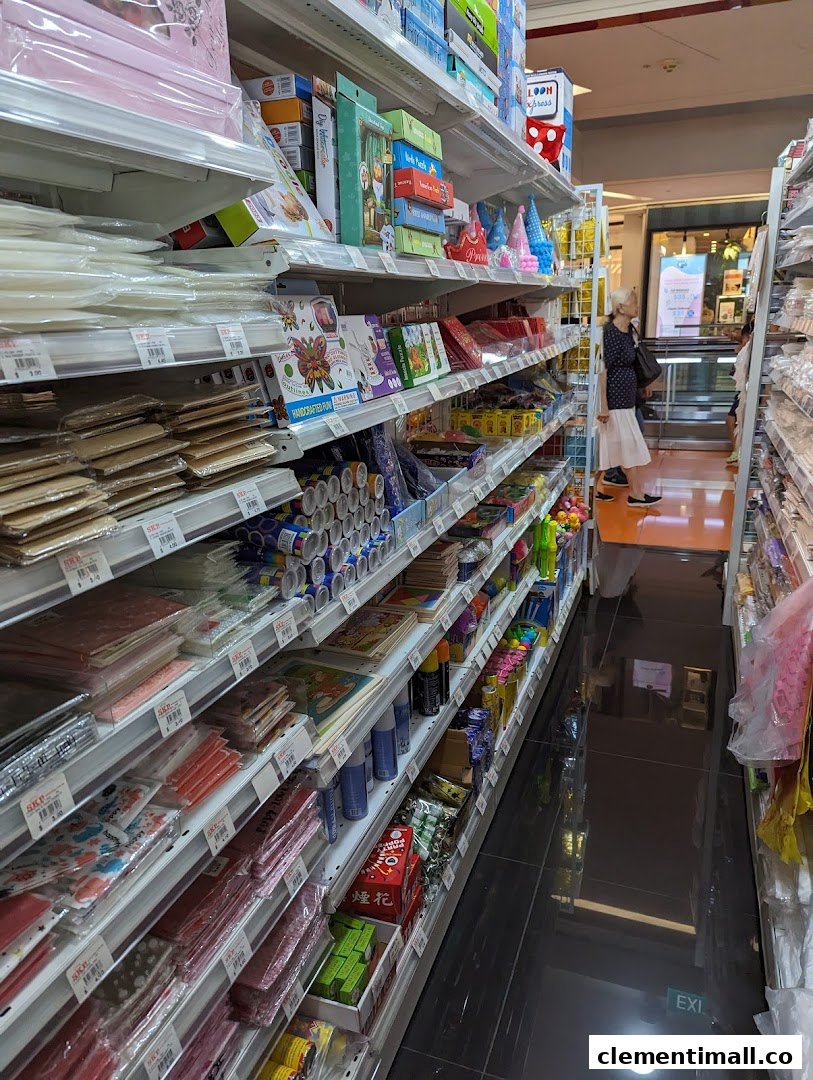 An aisle view inside SKP Clementi Mall, showcasing shelves filled with a wide array of party supplies, craft items, and stationery.