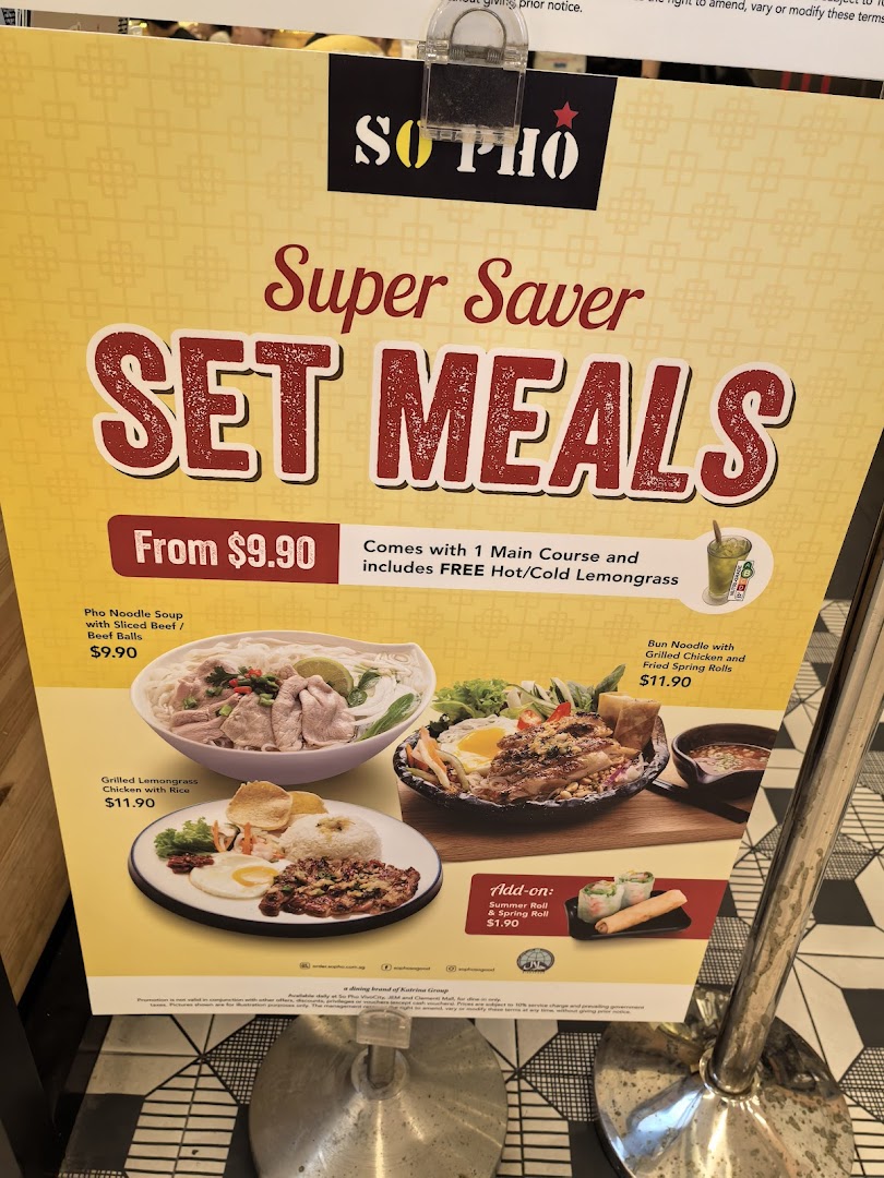 A promotional stand displaying 'Super Saver Set Meals' from So Pho, featuring Vietnamese dishes and prices.