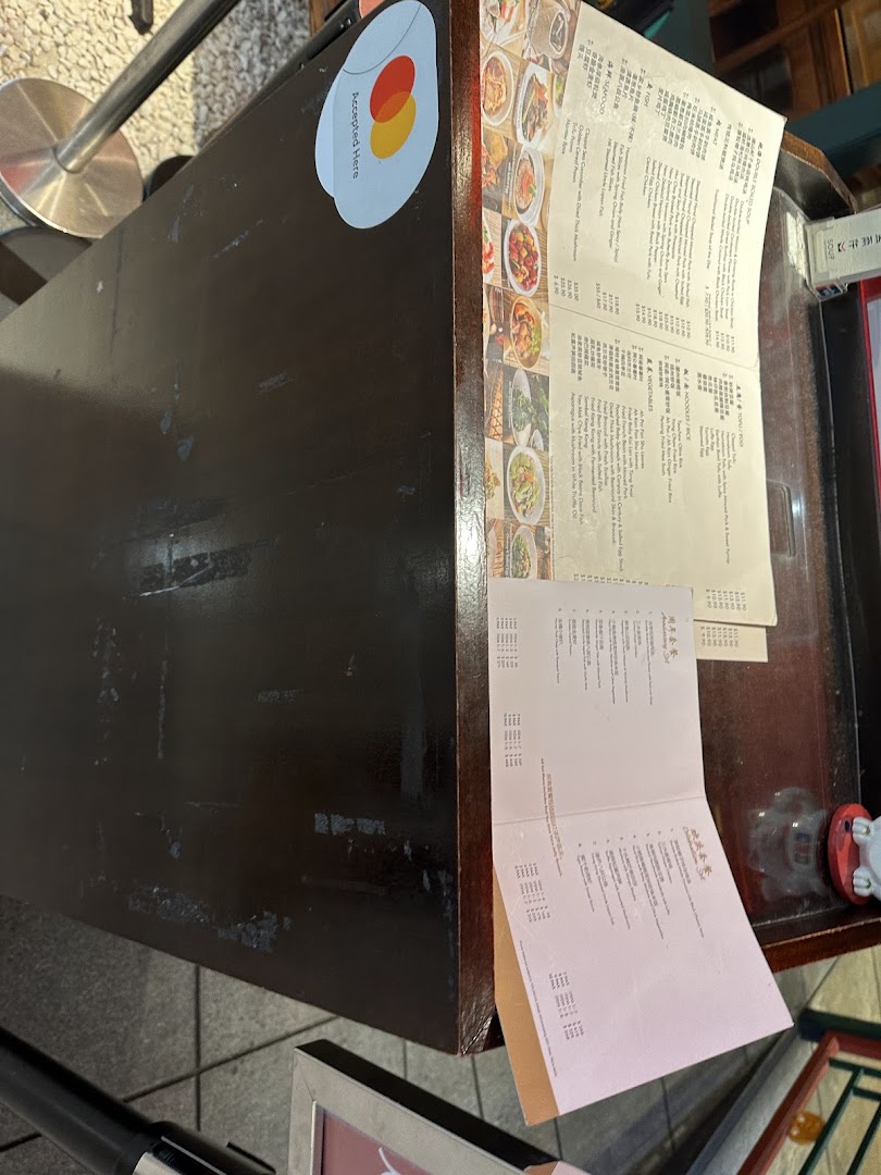 Two detailed menus displayed on a counter, showcasing a wide range of Chinese dishes.