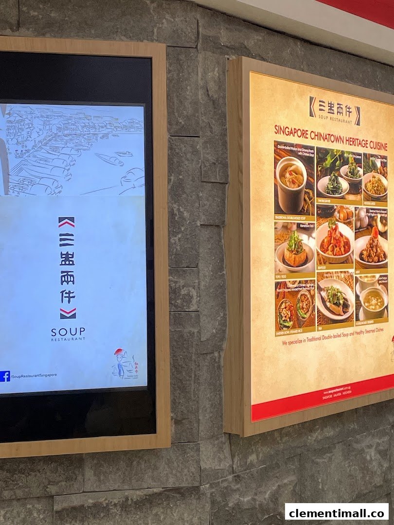 Exterior view of Soup Restaurant featuring a digital display and a backlit menu board.