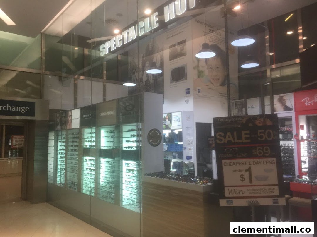 The shopfront of Spectacle Hut, an optical store, showcasing eyewear displays and a promotional sale sign.