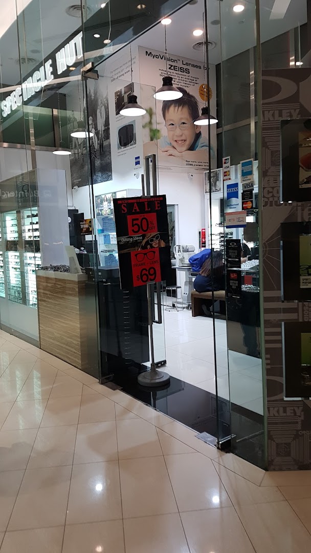 The glass entrance of Spectacle Hut, showcasing eyewear displays and promotional offers on frames and lenses.