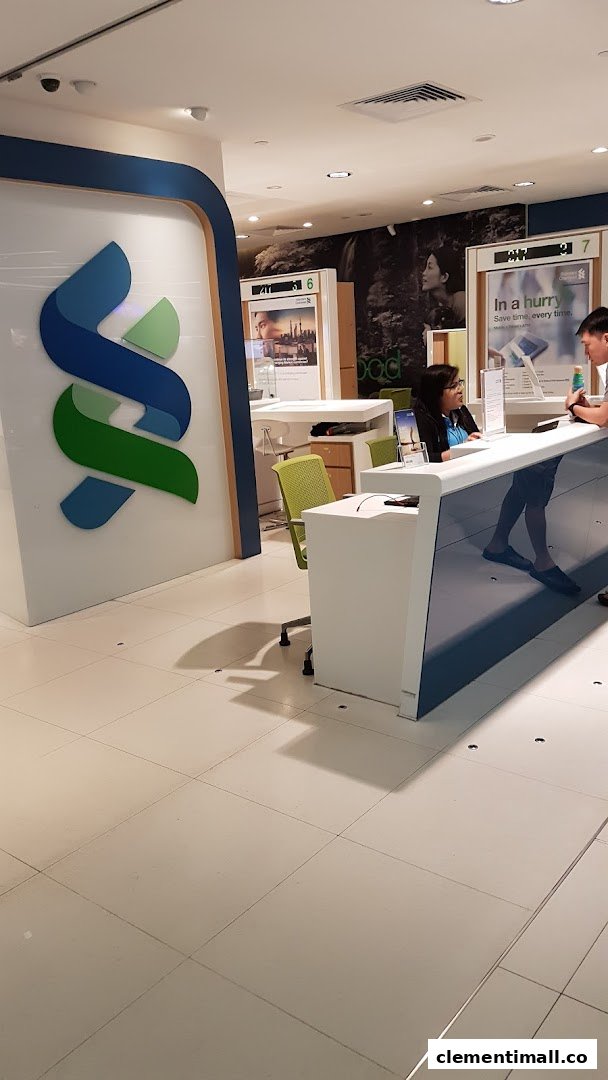 Interior view of Standard Chartered Bank, featuring customer service counters and branding.
