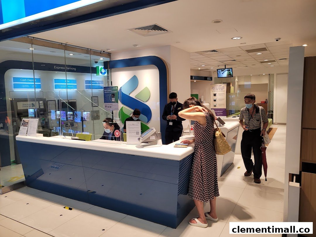 Interior view of Standard Chartered Bank with staff assisting customers and express banking machines.