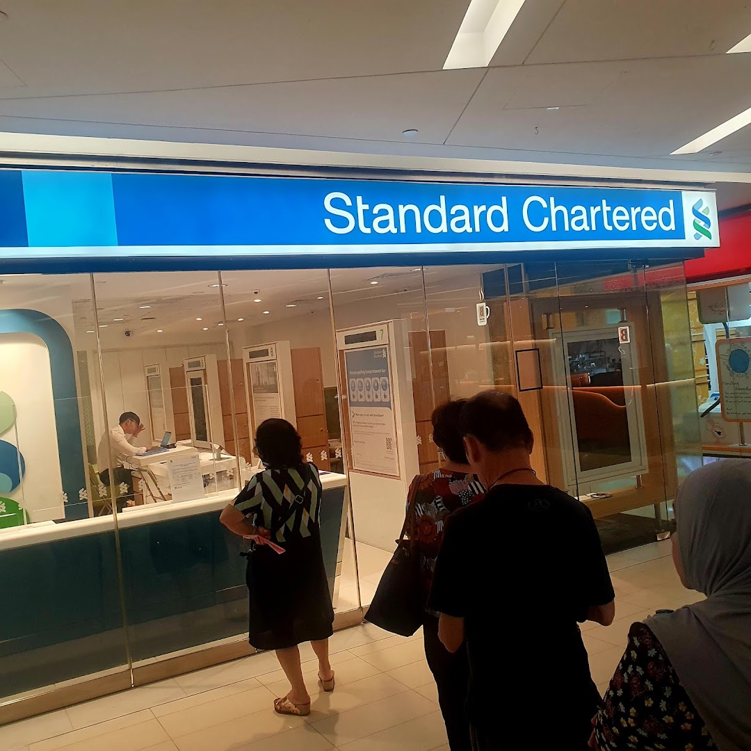 Customers queue outside Standard Chartered Bank at The Clementi Mall.