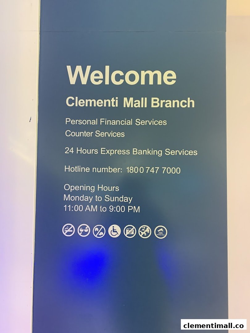 A blue sign displaying services, hotline, and opening hours for Standard Chartered Bank.