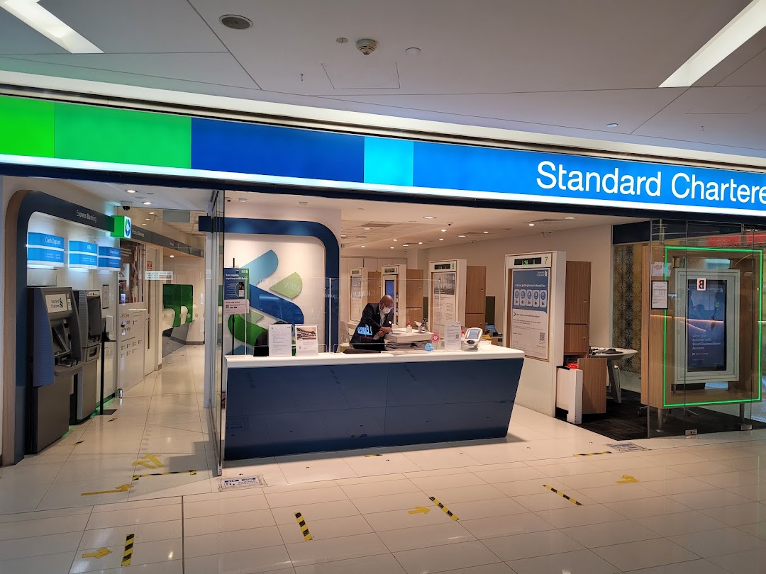 The entrance of Standard Chartered Bank at The Clementi Mall, featuring a service counter and ATMs.