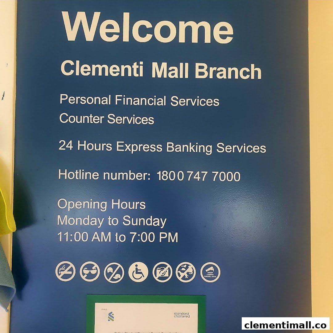 A blue informational sign for Standard Chartered Bank Clementi Mall branch detailing services, hotline, and operating hours.