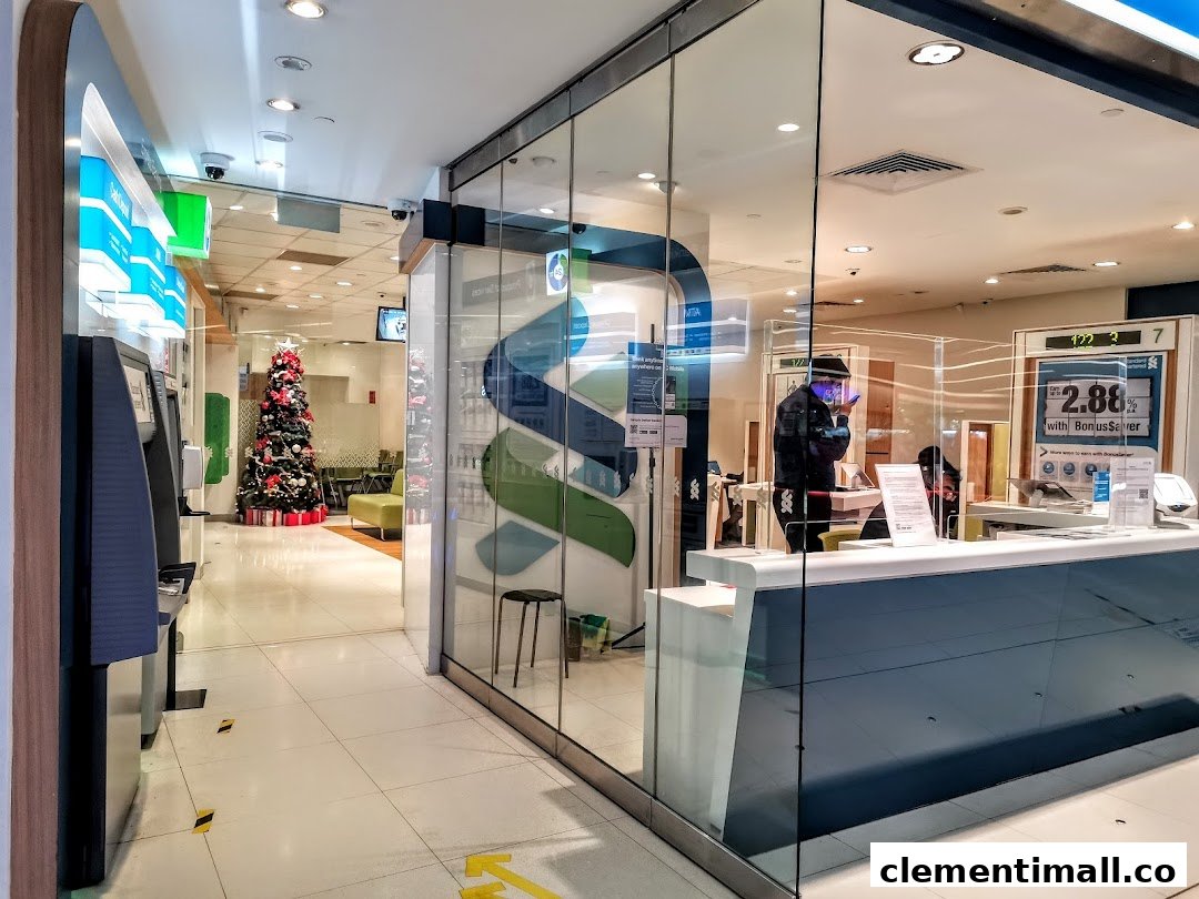Interior view of Standard Chartered Bank, featuring ATMs, a service counter, and festive decor.
