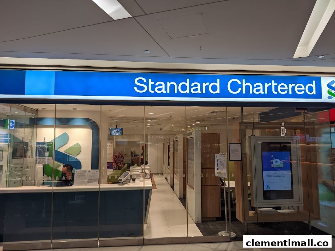 The brightly lit entrance of Standard Chartered Bank at The Clementi Mall, featuring its prominent blue signage.