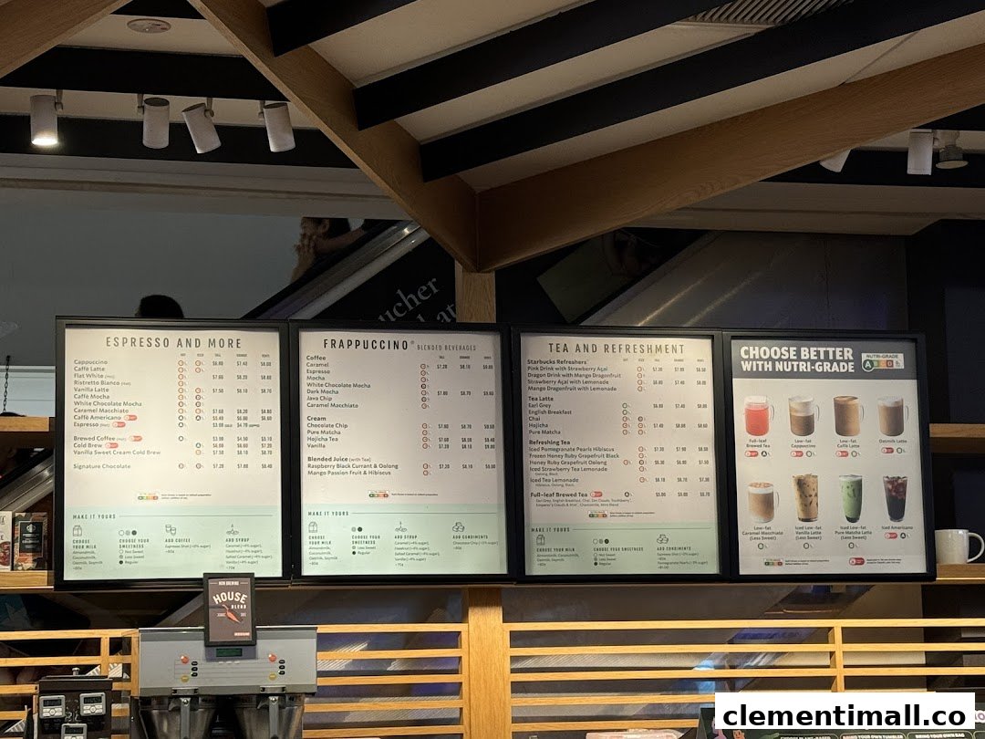 Multiple menu boards displaying coffee, frappuccino, tea, and refreshment options with prices at Starbucks.