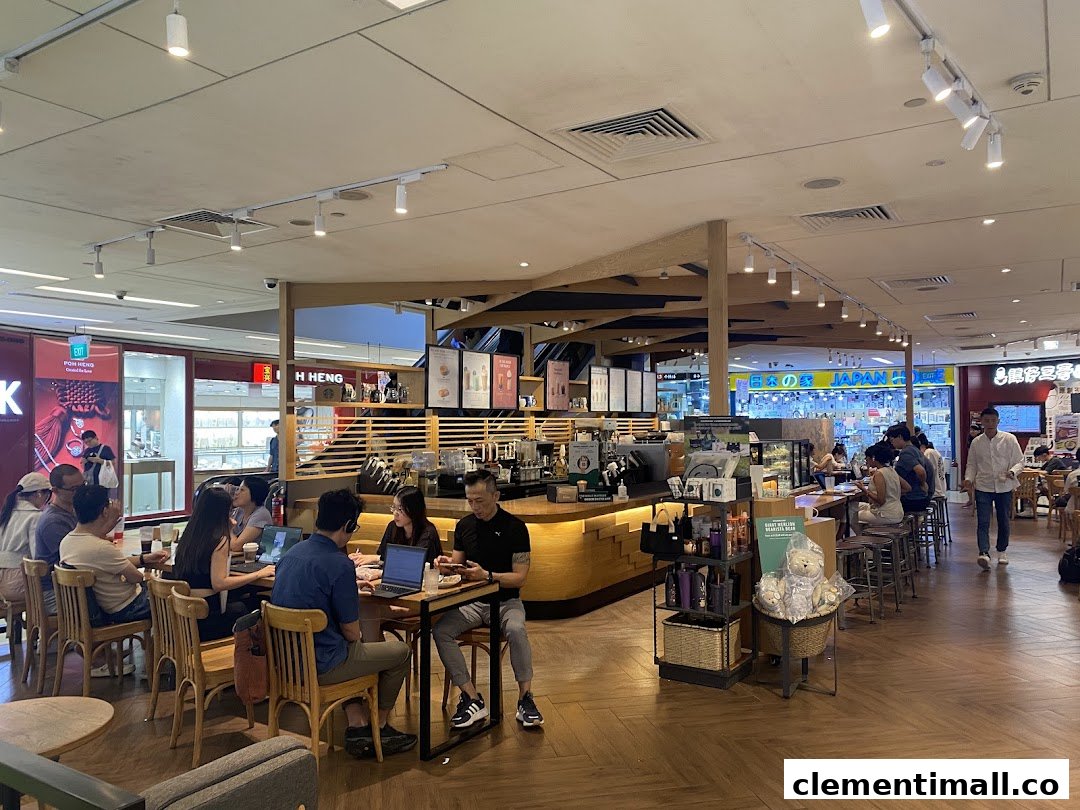 Customers enjoy coffee and work inside a bustling Starbucks cafe with a warm, inviting atmosphere.