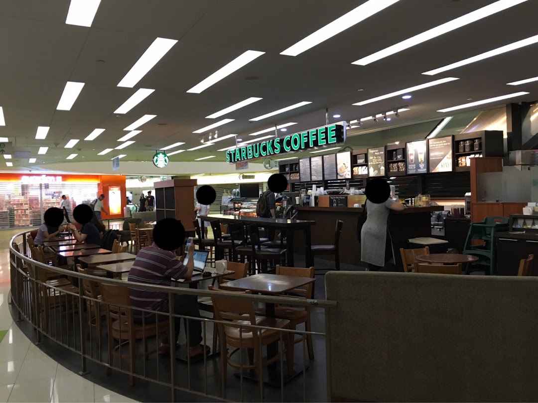 An interior view of Starbucks Clementi Mall with customers enjoying coffee and the cozy ambiance.