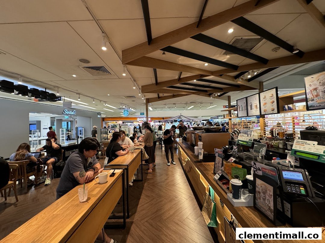 A bustling interior view of Starbucks Clementi Mall, showing customers enjoying drinks and the service counter.