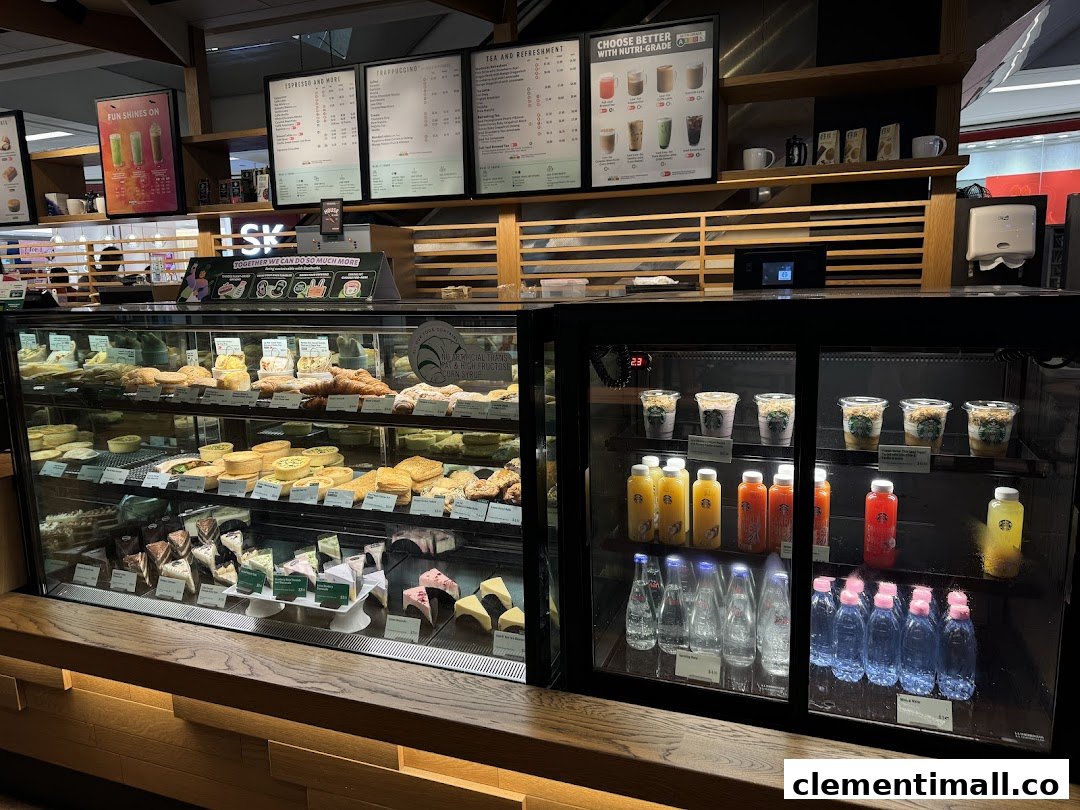 An interior view of Starbucks showcasing a vibrant display of pastries, cakes, and beverages in display cases.