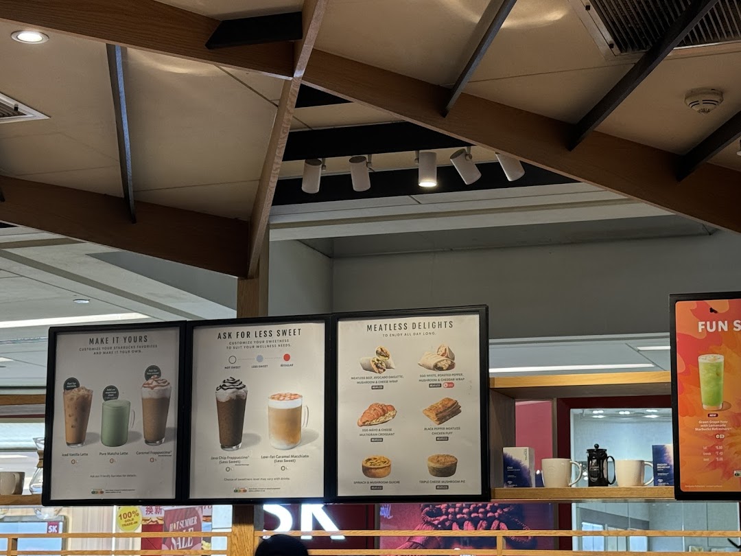 Close-up view of Starbucks menu boards showcasing customizable drinks and meatless food options.