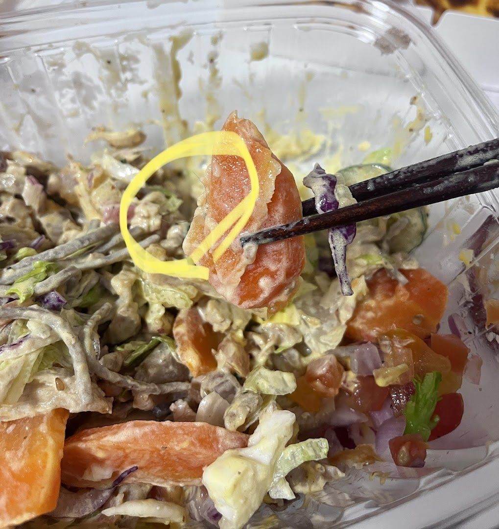 Close-up of a fresh, vibrant salad or bowl from Stuffd, featuring various ingredients and dressing.