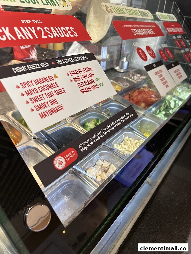 A close-up of Stuffd's food counter displaying fresh ingredients and sauce options.