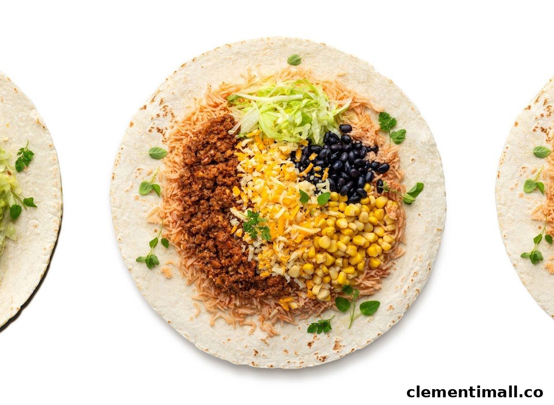 An overhead view of an open wrap filled with rice, ground meat, cheese, corn, black beans, and lettuce.