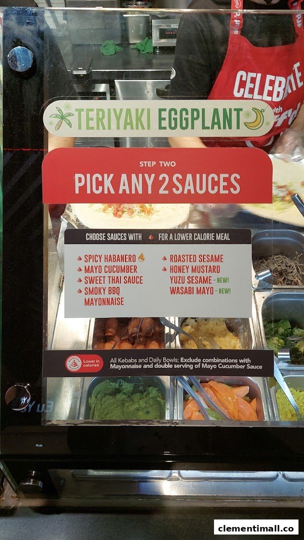 A Stuffd food counter display showing sauce options, a Teriyaki Eggplant special, and customization instructions.