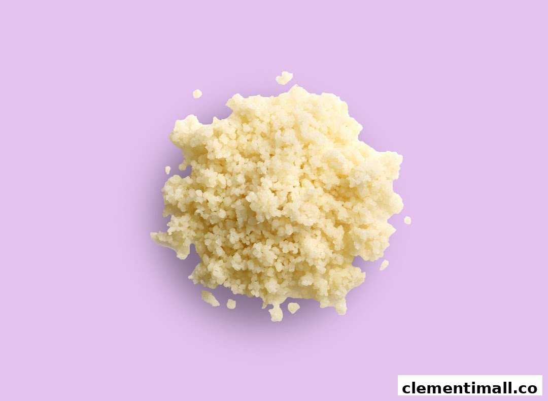 A close-up, top-down view of fluffy couscous or grains on a vibrant purple background.
