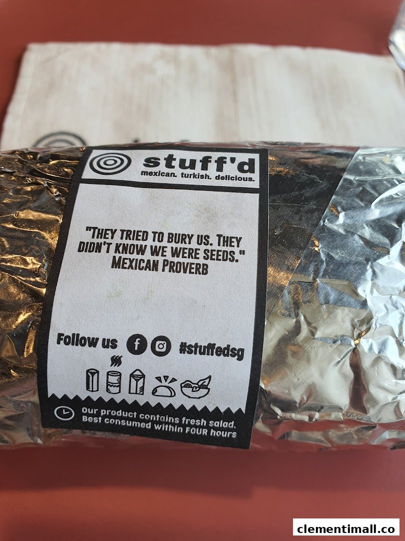 A foil-wrapped food item from Stuffd with a branded label featuring a Mexican proverb.