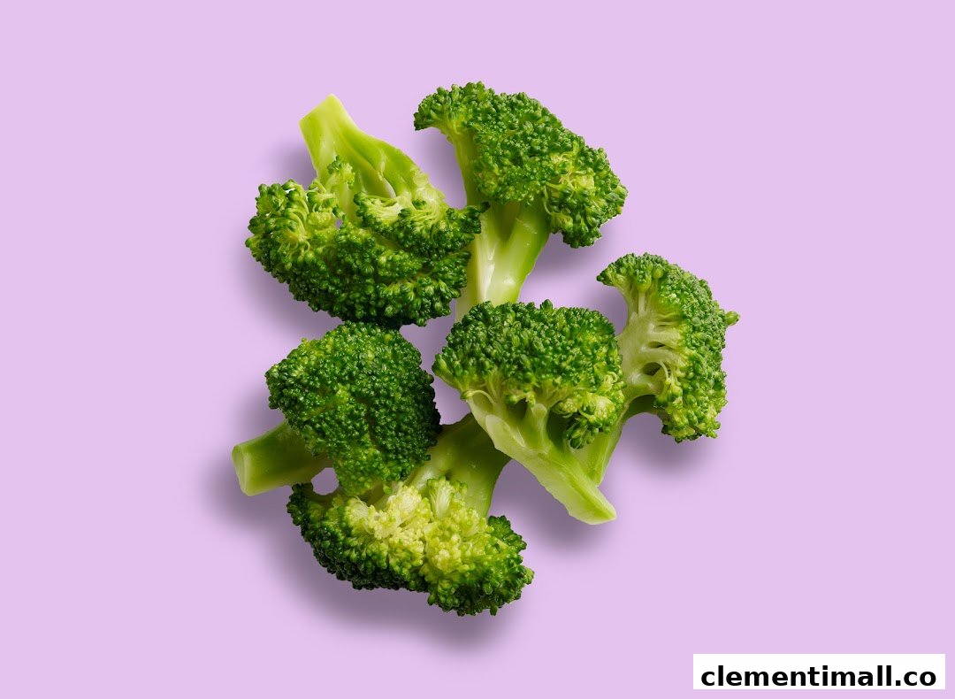 Fresh green broccoli florets are scattered on a light purple background.