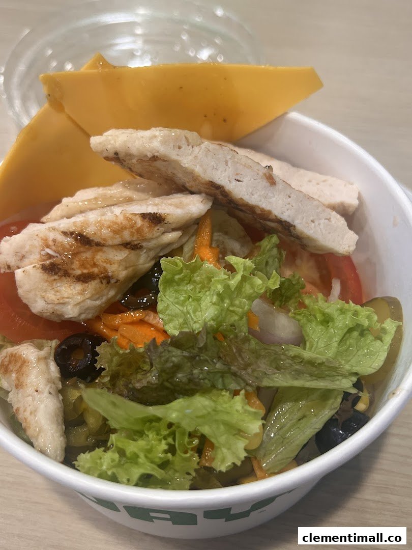 A fresh Subway salad bowl featuring grilled chicken, crisp lettuce, vegetables, and cheese slices.