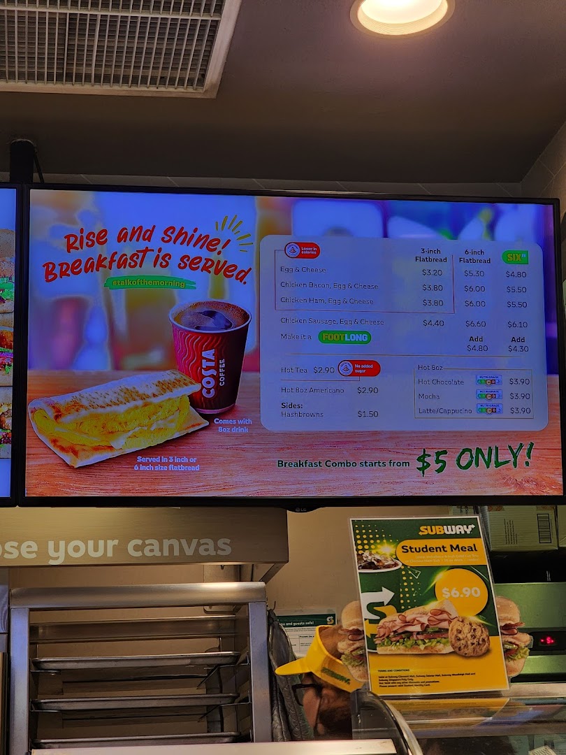 A digital menu board displaying Subway's breakfast options, drinks, and special offers.