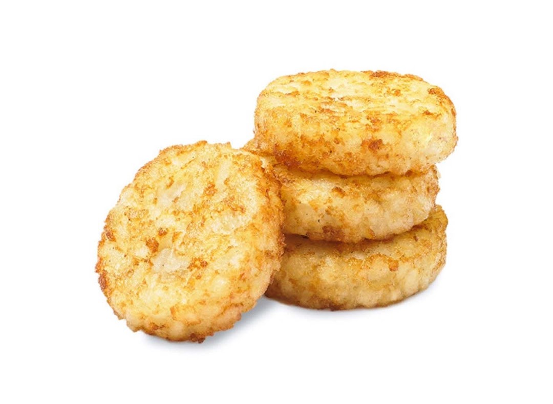 Golden brown hash browns, perfectly cooked and stacked, against a white background.