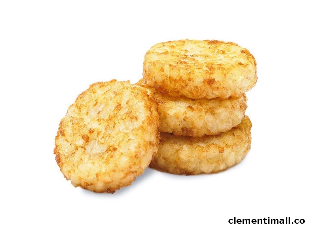 Golden brown hash browns, perfectly cooked and stacked, against a white background.
