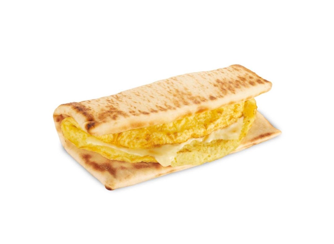 A close-up studio shot of a Subway breakfast flatbread sandwich with egg and cheese.