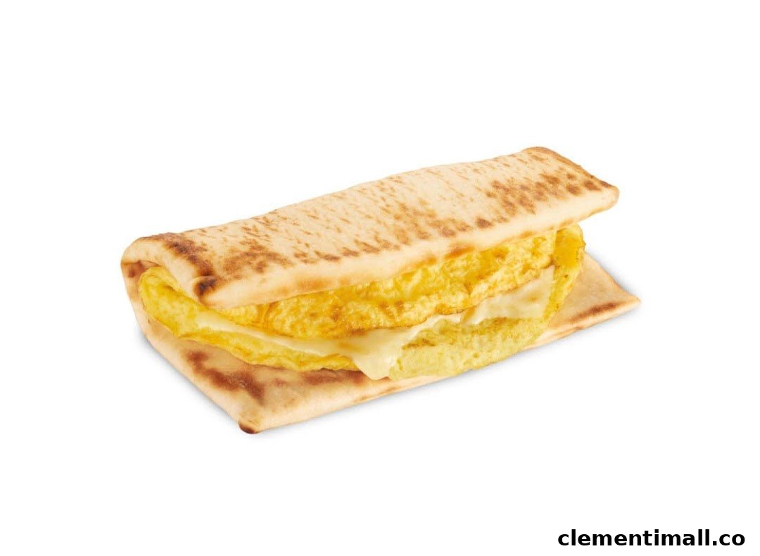 A close-up studio shot of a Subway breakfast flatbread sandwich with egg and cheese.