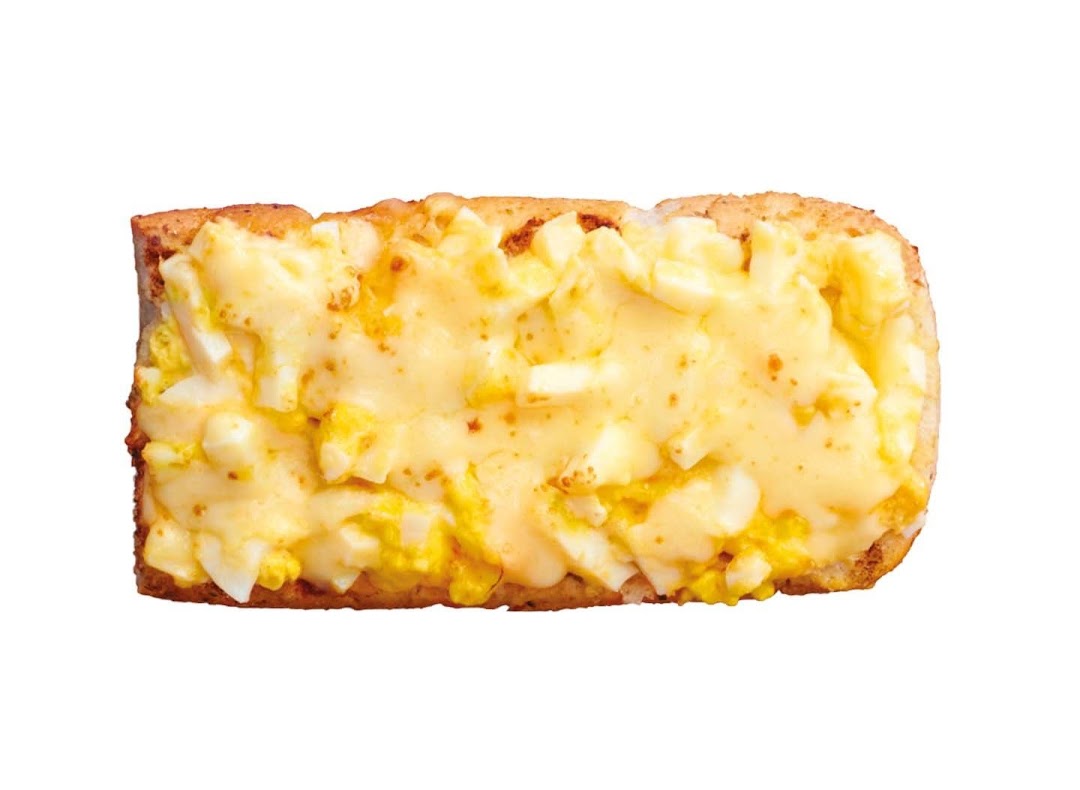 A close-up of a Subway egg salad sandwich with creamy filling and melted cheese.