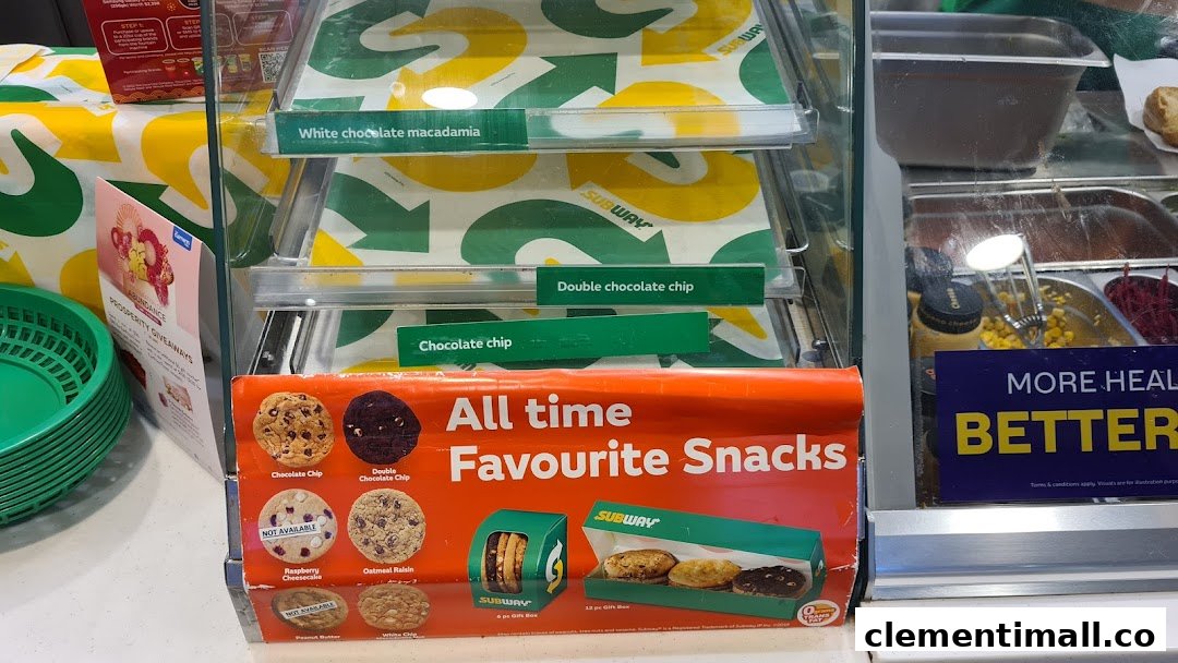 A display case at Subway featuring cookies, snacks, and fresh sandwich ingredients.