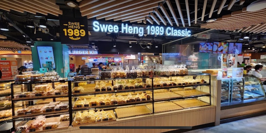 Interior view of Swee Heng 1989 Classic bakery with display cases filled with various baked goods.