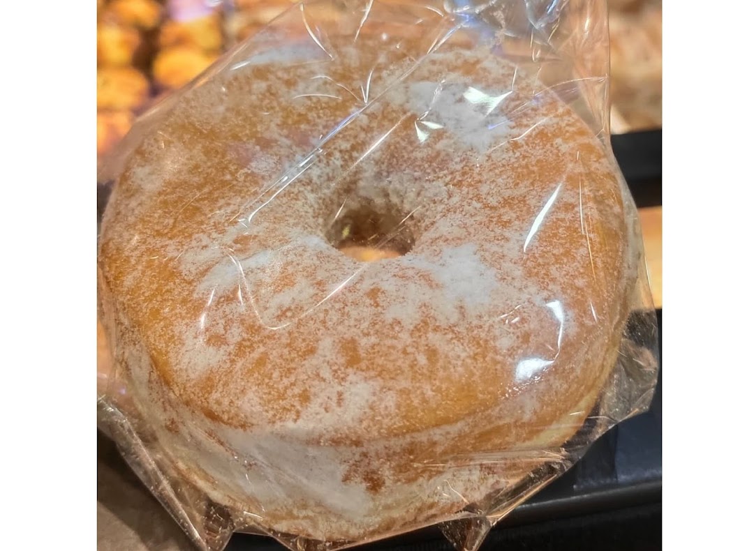 A sugar-dusted donut, individually wrapped, from Swee Heng 1989 Classic.