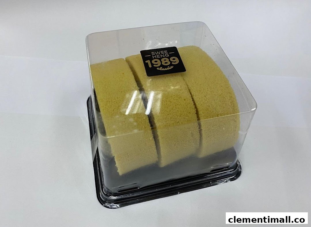A sliced cake roll in a clear plastic container with the 'Swee Heng 1989 Classic' label.