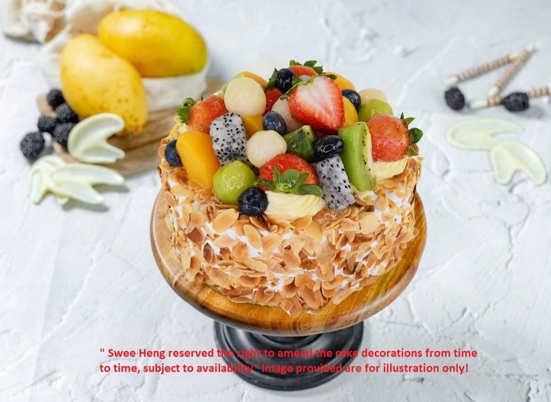 A beautifully decorated cake topped with fresh fruits and almond flakes.