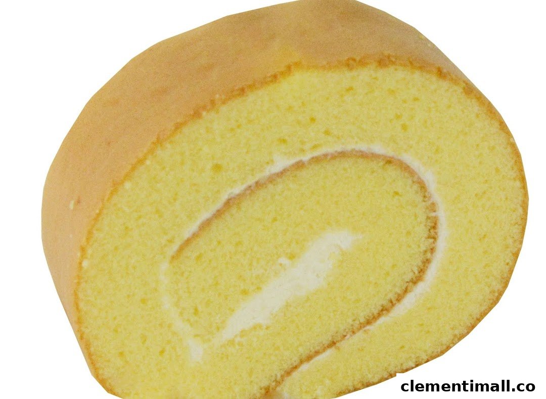 A close-up of a classic vanilla Swiss roll with creamy white filling.