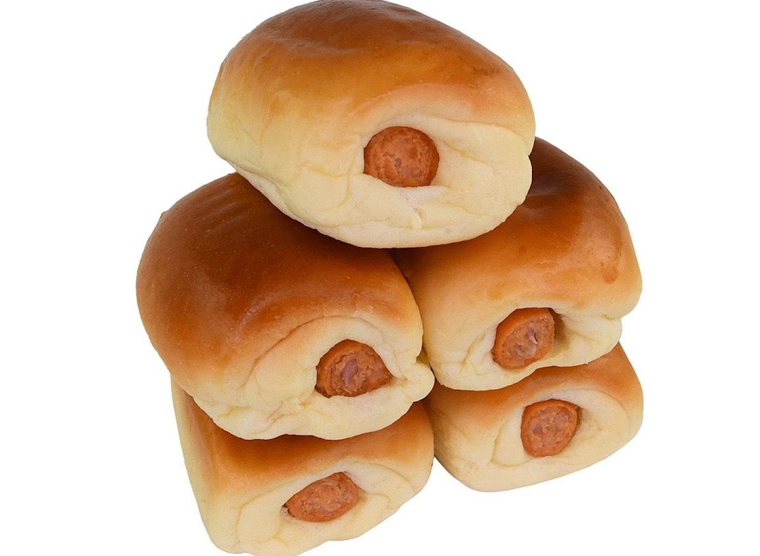A stack of golden-brown sausage buns with visible sausage ends.
