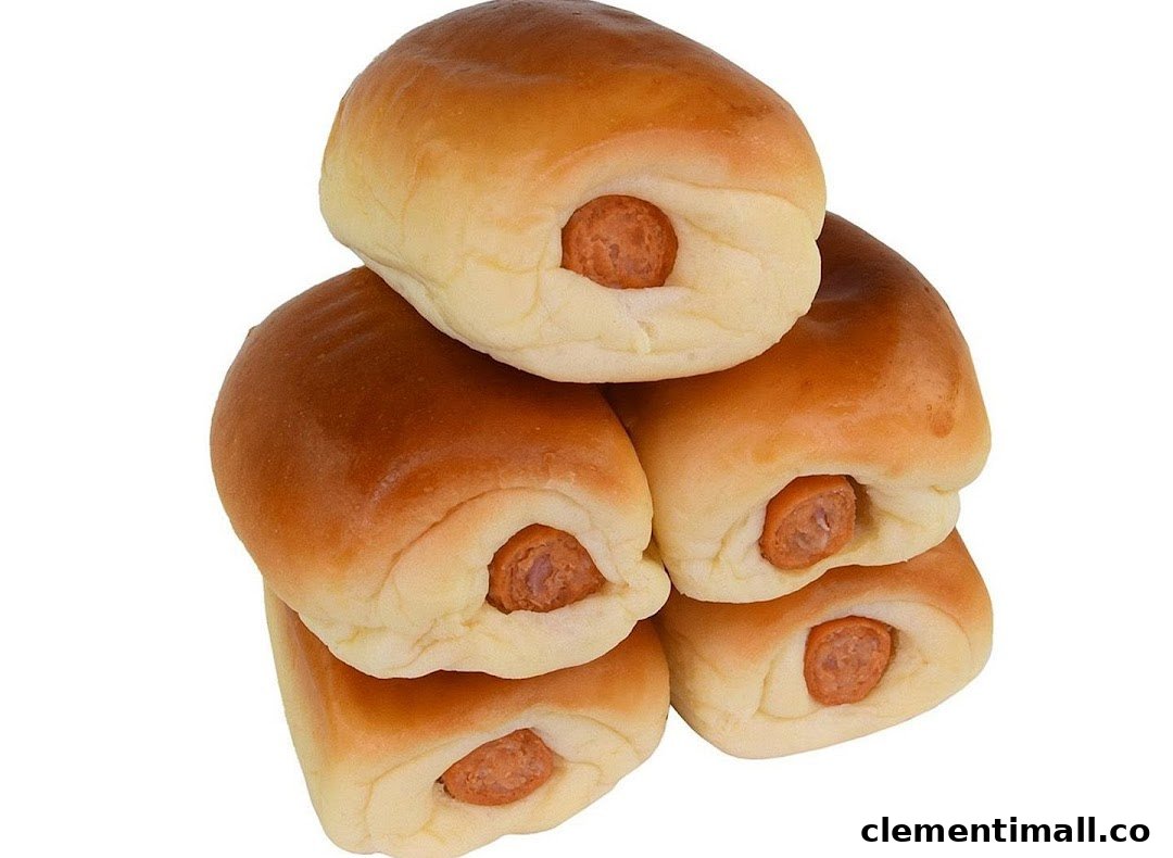 A stack of golden-brown sausage buns with visible sausage ends.