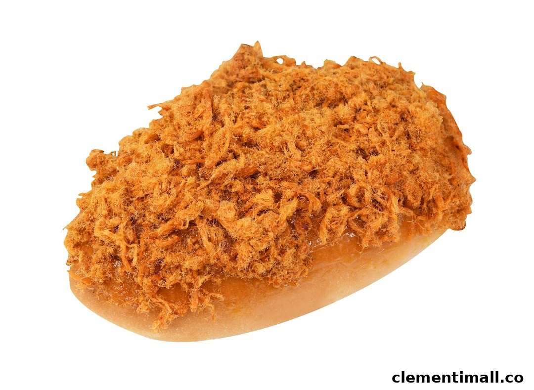 A close-up of a golden-brown bun generously topped with savory meat floss.